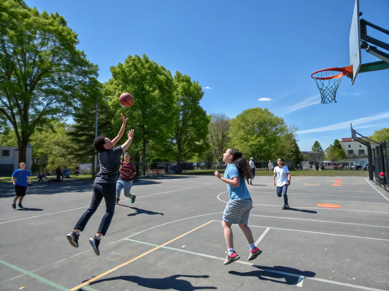 A group of students participating in a basketball game, showcasing teamwork and sportsmanship, with the ASS SPORTIVE DU COLLEGE D AIGRE logo subtly visible in the background.