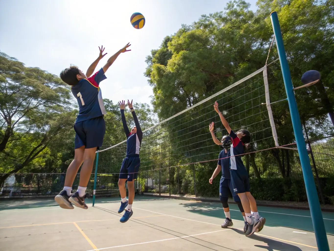 A collaborative image of students working together during a volleyball practice, emphasizing the importance of communication and strategy.